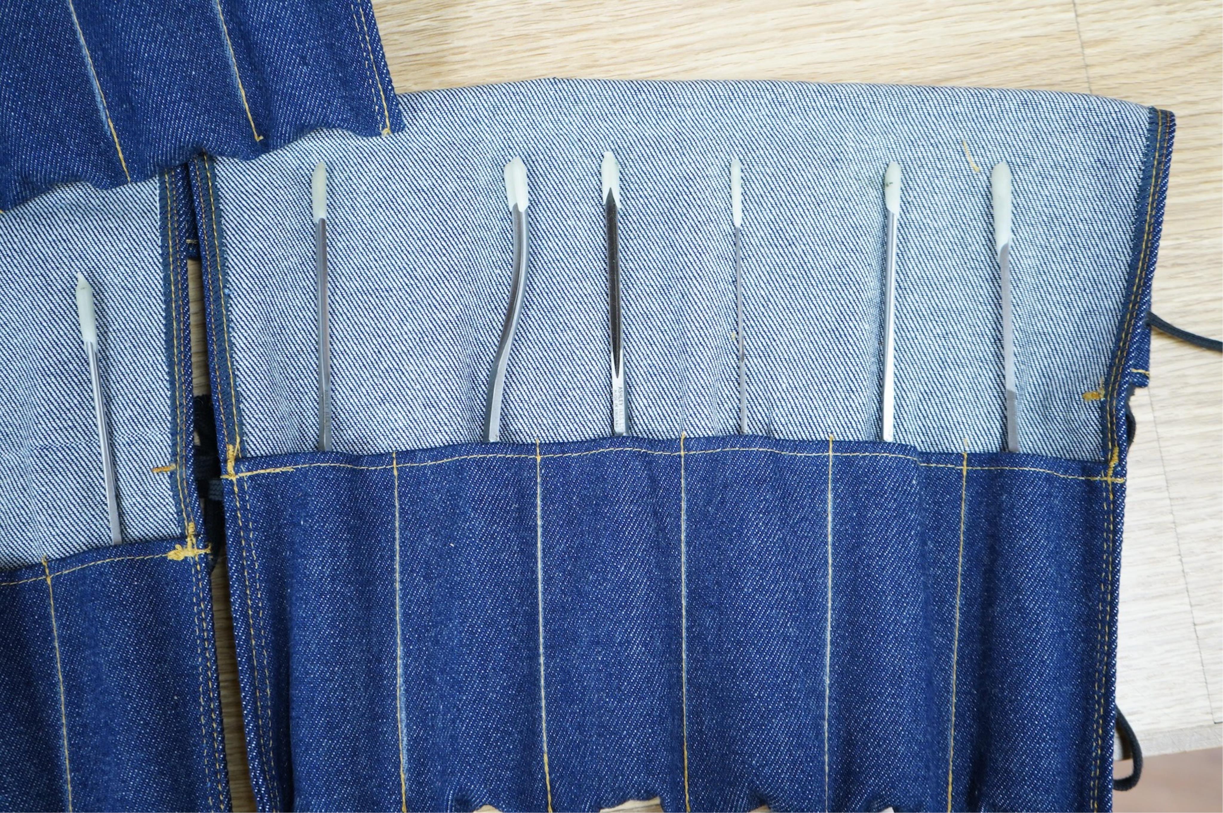 Three sets of Ashley Iles wood carving tools, contained within denim tool rolls; the York Set, the Supplementary Set No.Two, and the Supplementary Set No.Three, each comprising of six chisels (18 chisels in total)